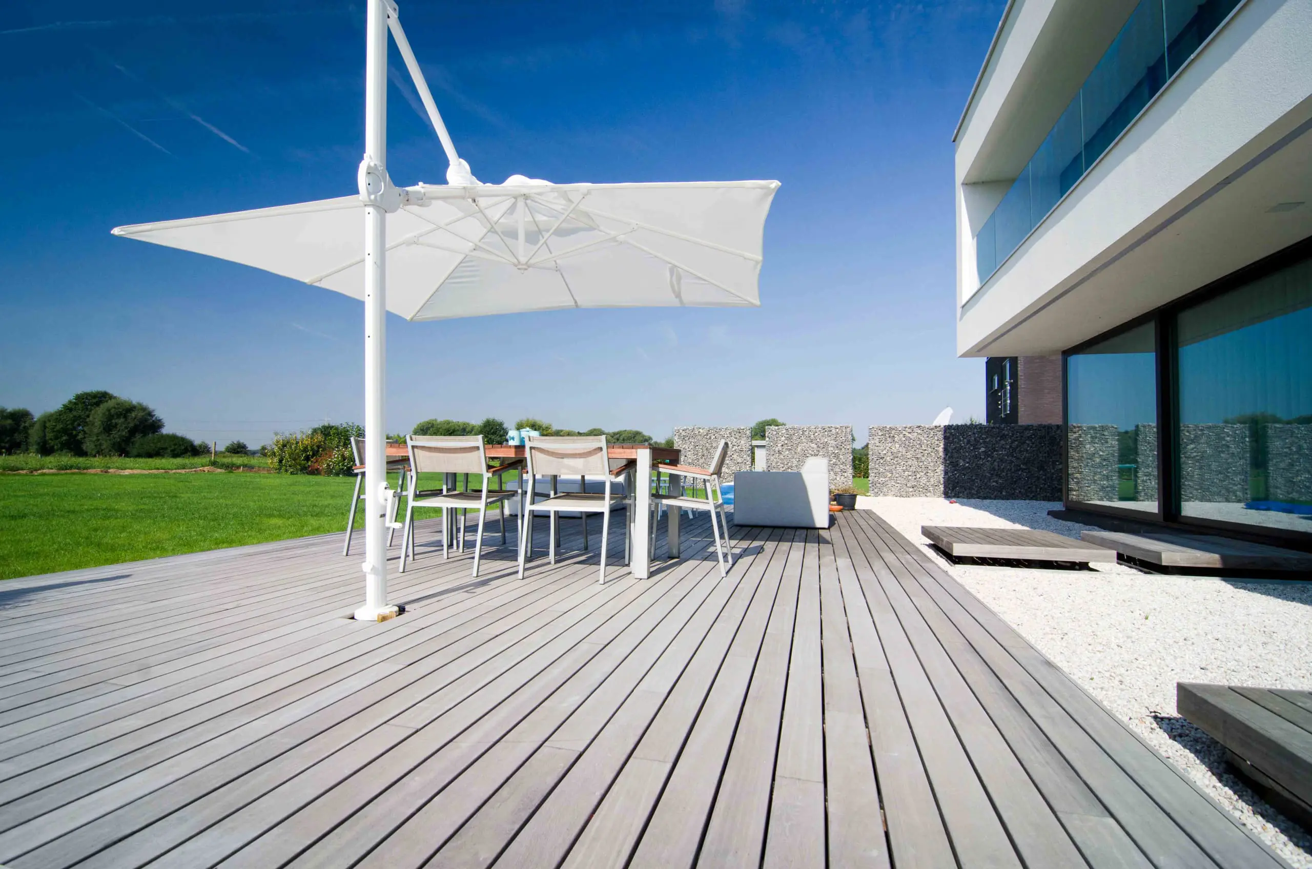 Vetedy Padouk Terrasse hellgrau mit Sonnenschirm. Terrasse Vetedy Padouk claire avec parasol.